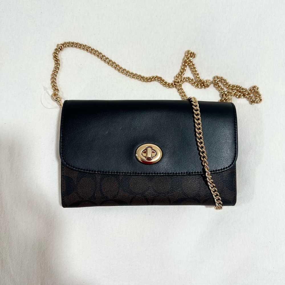 It’s a coach signature crossbody bag